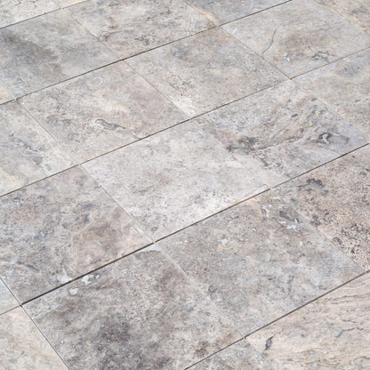 Elegant pewter vase displayed on a polished travertine surface, illustrating a blend of classic and modern decor.