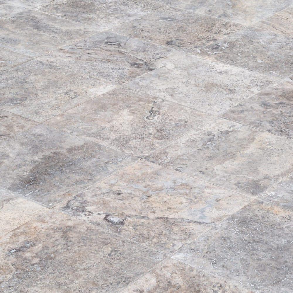Elegant pewter vase displayed on a polished travertine surface, illustrating a blend of classic and modern decor.