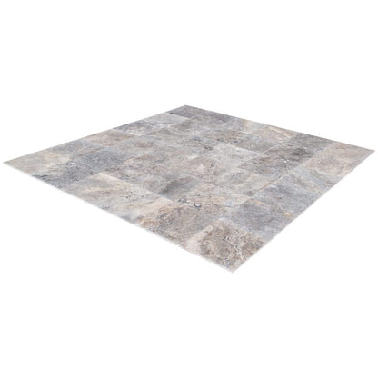 Elegant pewter vase displayed on a polished travertine surface, illustrating a blend of classic and modern decor.