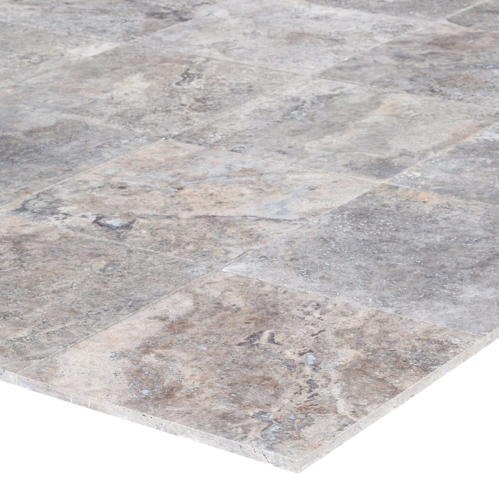 Elegant pewter vase displayed on a polished travertine surface, illustrating a blend of classic and modern decor.