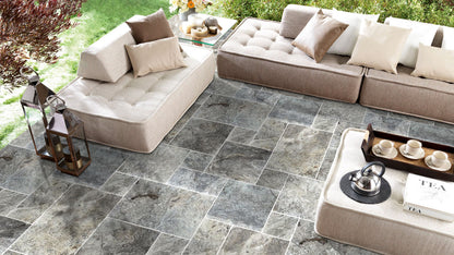 Elegant silver decor complimenting natural travertine stone for sophisticated interior design.