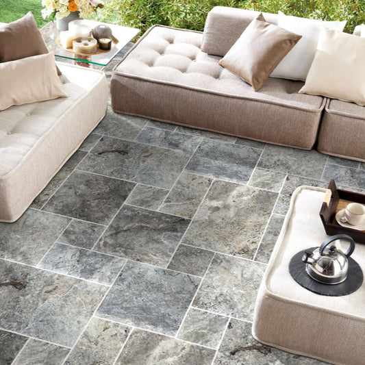 Elegant silver decor complimenting natural travertine stone for sophisticated interior design.