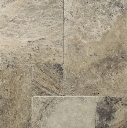 Elegant silver decor complimenting natural travertine stone for sophisticated interior design.