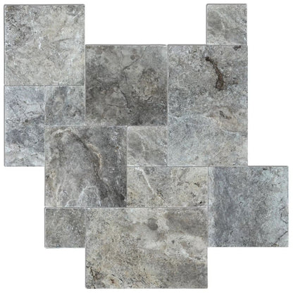 Elegant silver decor complimenting natural travertine stone for sophisticated interior design.