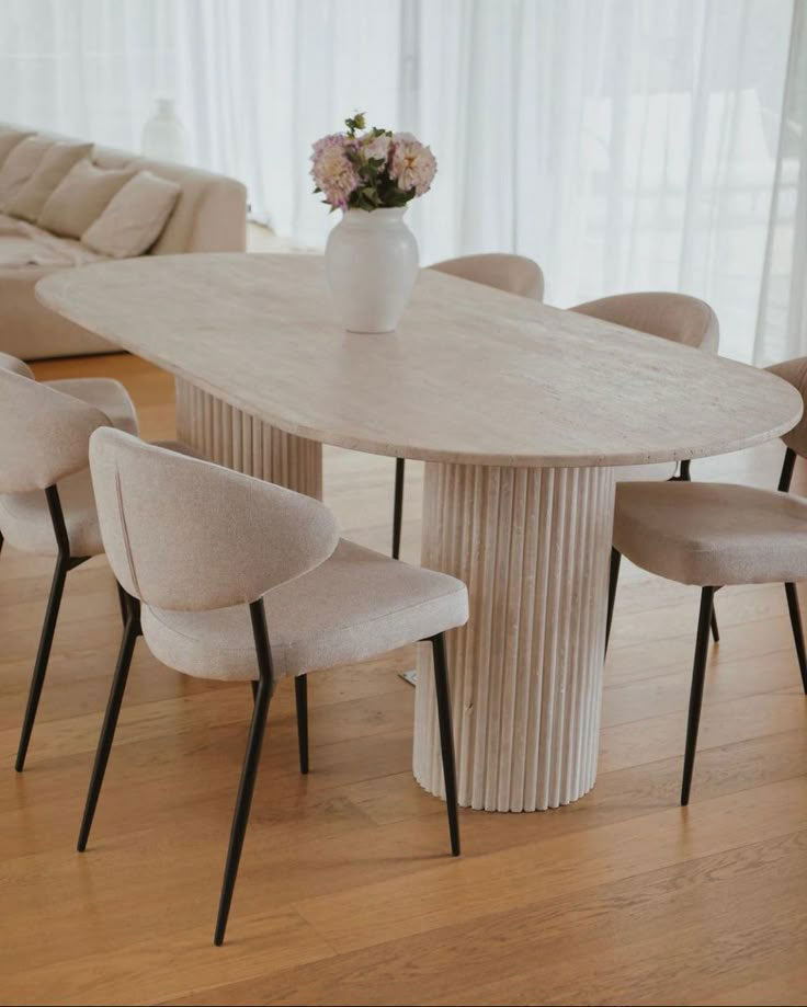 Elegant travertine dining table showcasing natural stone texture and sophisticated design for upscale interiors.