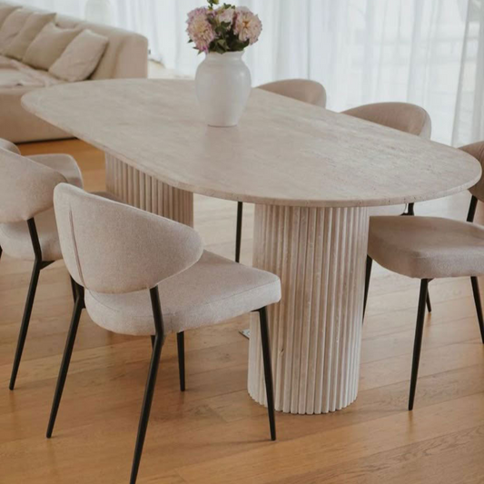 Elegant travertine dining table showcasing natural stone texture and sophisticated design for upscale interiors.