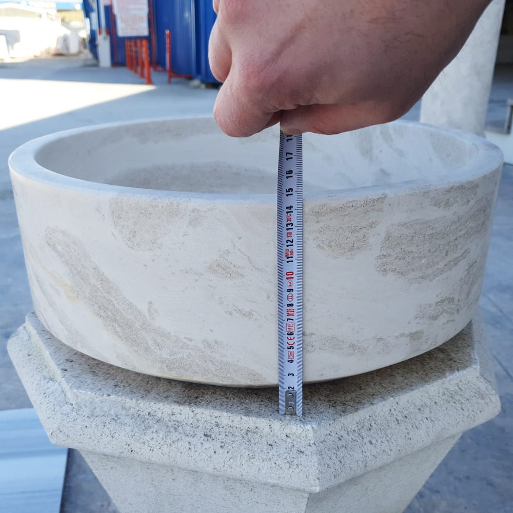 Elegant limestone vessel sink showcasing natural stone texture, perfect for modern bathroom designs