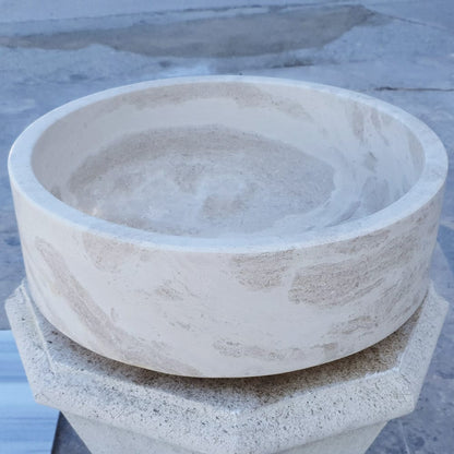 Elegant limestone vessel sink showcasing natural stone texture, perfect for modern bathroom designs