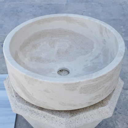 Elegant limestone vessel sink showcasing natural stone texture, perfect for modern bathroom designs