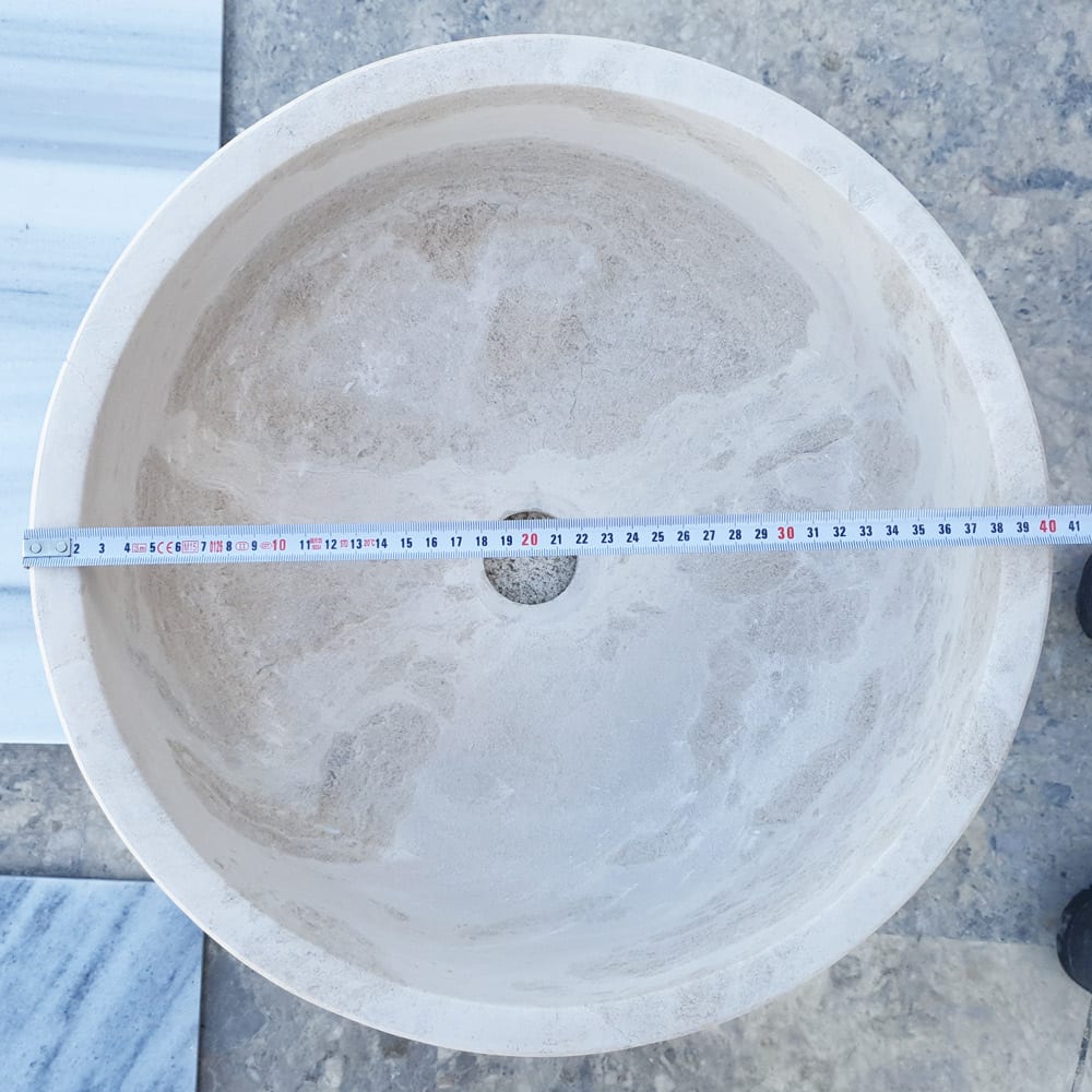 Elegant limestone vessel sink showcasing natural stone texture, perfect for modern bathroom designs