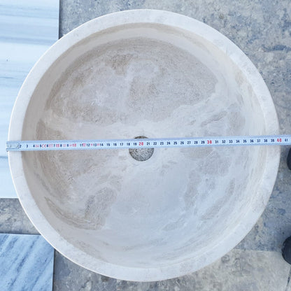 Elegant limestone vessel sink showcasing natural stone texture, perfect for modern bathroom designs