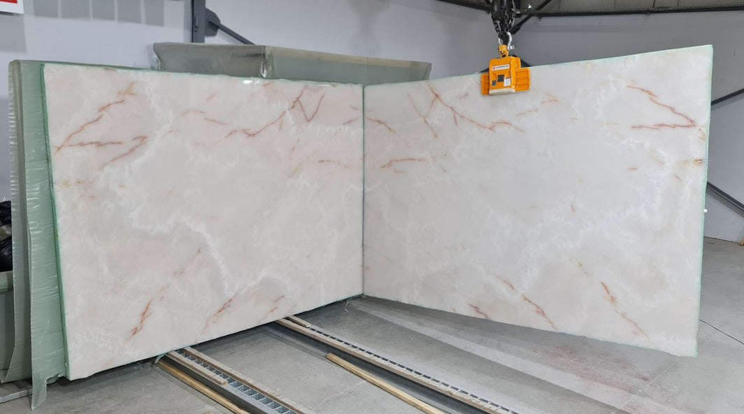 White Onyx bookmatching slabs showcasing luxurious natural stone patterns for elegant interior design