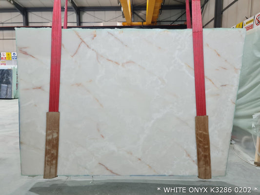 White Onyx bookmatching slabs showcasing luxurious natural stone patterns for elegant interior design